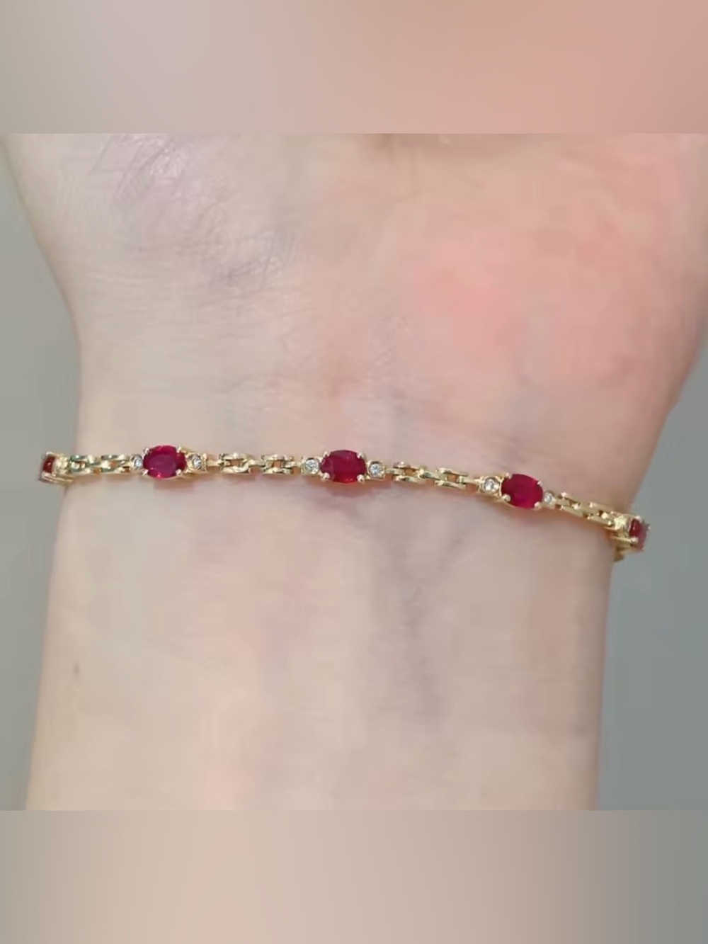 Gold Bracelet with Red Gem Accents